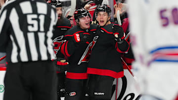 Nov 27, 2024; Raleigh, North Carolina, USA;  Carolina Hurricanes right wing Jackson Blake (53) is congratulated by defenseman Brent Burns (8) and center Jack Drury (18) after his goal against the New York Rangers during the third period at Lenovo Center. Mandatory Credit: James Guillory-Imagn Images