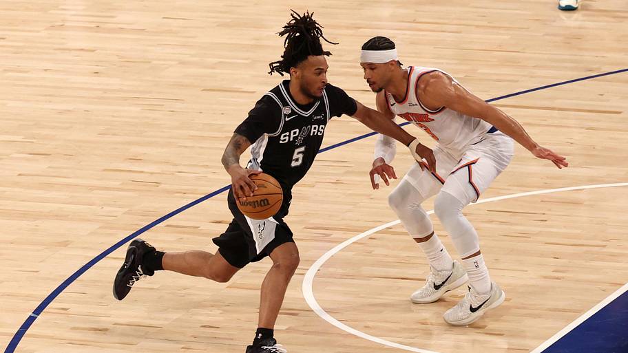 San Antonio Spurs guard Stephon Castle controls the ball against New York Knicks guard Josh Hart.