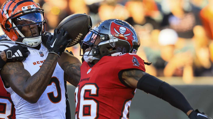 Aug 10, 2024; Cincinnati, Ohio, USA; Cincinnati Bengals wide receiver Tee Higgins (5) attempts to catch a pass against Tampa Bay Buccaneers safety Kaevon Merriweather (26) in the first half at Paycor Stadium. Mandatory Credit: Katie Stratman-USA TODAY Sports