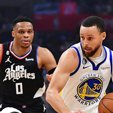 Mar 15, 2023; Los Angeles, California, USA; Golden State Warriors guard Stephen Curry (30) moves the ball against Los Angeles Clippers center Ivica Zubac (40) guard Russell Westbrook (0) and forward Marcus Morris Sr. (8during the first half at Crypto.com Arena. 