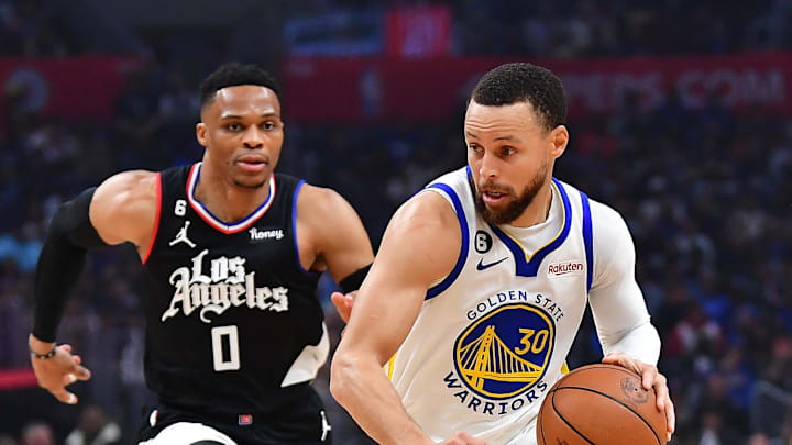 Mar 15, 2023; Los Angeles, California, USA; Golden State Warriors guard Stephen Curry (30) moves the ball against Los Angeles Clippers center Ivica Zubac (40) guard Russell Westbrook (0) and forward Marcus Morris Sr. (8during the first half at Crypto.com Arena. 