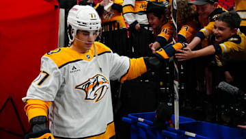 Mar 25, 2025; Raleigh, North Carolina, USA;  Nashville Predators right wing Luke Evangelista (77) goes past the fans on his way to the ice for the the warmups before the game against the Carolina Hurricanes at Lenovo Center. Mandatory Credit: James Guillory-Imagn Images