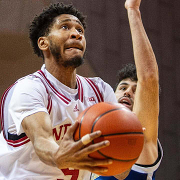 Indiana's Kanaan Carlyle (9) scores past Chattanooga's Jack Kostel (11) during the Indiana versus Chattanooga men's basketball game at Simon Skjodt Assembly Hall on Saturday, Dec. 21, 2204.