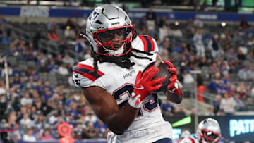 Aug 21, 2025; East Rutherford, New Jersey, USA; New England Patriots safety Kyle Dugger (23) interception a pass in the end zone during the first half against the New York Giants at MetLife Stadium. Mandatory Credit: Vincent Carchietta-Imagn Images