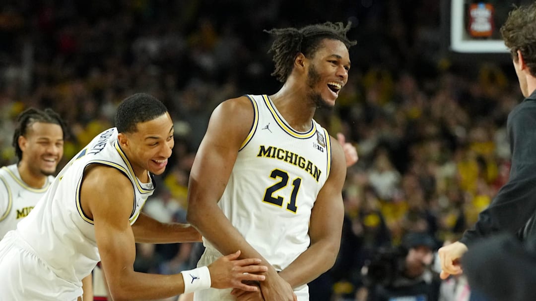 Apr 6, 2026; Indianapolis, IN, USA; Michigan Wolverines forward Morez Johnson Jr. (21) and guard Nimari Burnett (4) celebrate after their win against the UConn Huskies in the national championship of the Final Four of the men's 2026 NCAA Tournament between the  and the Michigan Wolverines at Lucas Oil Stadium. Mandatory Credit: Bob Donnan-Imagn Images