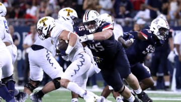 Sep 2, 2023; Tucson, Arizona, USA; Arizona Wildcats defensive lineman Bill Norton (45) tackles Northern Arizona Lumberjacks running back TJ McDaniel (1) during the second half at Arizona Stadium. Mandatory Credit: Zac BonDurant-USA TODAY Sports