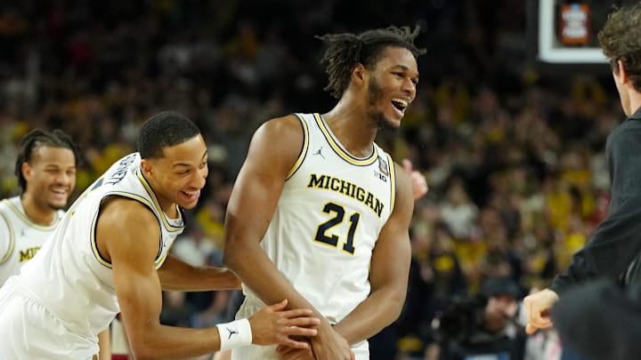 Apr 6, 2026; Indianapolis, IN, USA; Michigan Wolverines forward Morez Johnson Jr. (21) and guard Nimari Burnett (4) celebrate after their win against the UConn Huskies in the national championship of the Final Four of the men's 2026 NCAA Tournament between the  and the Michigan Wolverines at Lucas Oil Stadium. Mandatory Credit: Bob Donnan-Imagn Images