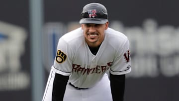 Wisconsin Timber Rattlers' manager Victor Estevez (7) smiles along the third base line against the West Michigan Whitecaps Tuesday, July 9, 2024, at Neuroscience Group Field at Fox Cities Stadium in Grand Chute, Wisconsin. The Timber Rattlers won 4-0.