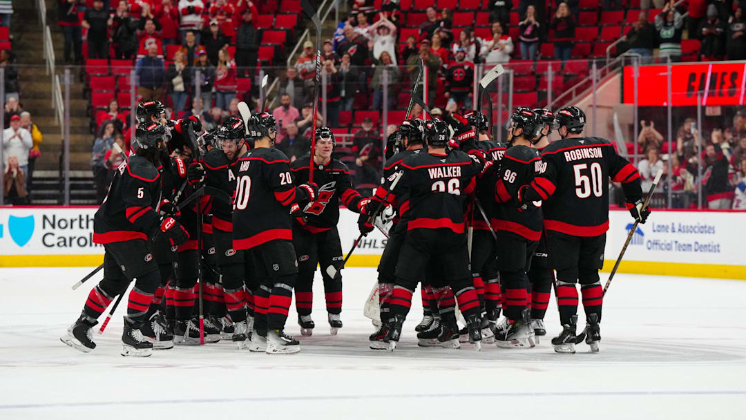 Apr 12, 2025; Raleigh, North Carolina, USA;  Carolina Hurricanes players celebrate there victory against the New York Rangers at Lenovo Center. Mandatory Credit: James Guillory-Imagn Images