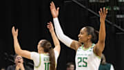 Oregon’s Peyton Scott, left, and Deja Kelly celebrate with fans as the win over Rutgers becomes certain at Matthew Knight Arena Sunday, Feb. 23, 2025 in Eugene, Oregon.