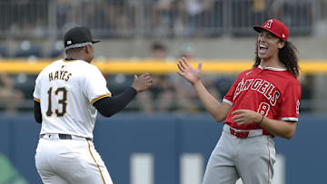 May 7, 2024; Pittsburgh, Pennsylvania, USA; Los Angeles Angels third baseman Cole Tucker (8) reacts as he greets Pittsburgh Pirates third baseman Ke'Bryan Hayes (13) before their game at PNC Park. 