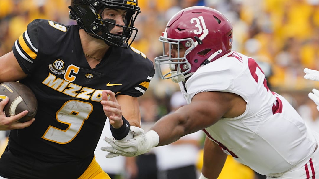 Oct 11, 2025; Columbia, Missouri, USA; Missouri Tigers quarterback Beau Pribula (9) runs the ball against Alabama Crimson Tide defensive lineman Keon Keeley (31) during the second half of the game at Faurot Field at Memorial Stadium. Mandatory Credit: Jay Biggerstaff-Imagn Images Oct 11, 2025; Columbia, Missouri, USA; Missouri Tigers quarterback Beau Pribula (9) runs the ball against Alabama Crimson Tide defensive lineman Keon Keeley (31) during the second half of the game at Faurot Field at Memorial Stadium. Mandatory Credit: Jay Biggerstaff-Imagn Images