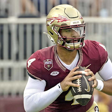 Sep 14, 2024; Tallahassee, Florida, USA; Florida State Seminoles quarterback DJ Uiagalelei (4) rolls out to pass against the Memphis Tigers during the first half at Doak S. Campbell Stadium. Mandatory Credit: Melina Myers-Imagn Images