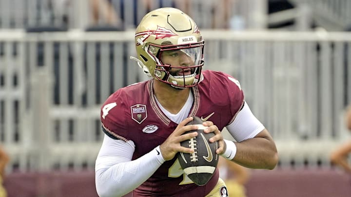 Sep 14, 2024; Tallahassee, Florida, USA; Florida State Seminoles quarterback DJ Uiagalelei (4) rolls out to pass against the Memphis Tigers during the first half at Doak S. Campbell Stadium. Mandatory Credit: Melina Myers-Imagn Images