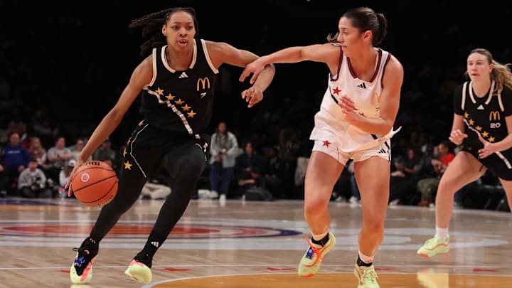 Apr 1, 2025; Brooklyn, NY, USA; McDonald's All American East wing Nyla Brooks (7) dribbles the ball against McDonald's All American West guard Addie Deal (7) during the second half of the game at Barclays Center. Mandatory Credit: Pamela Smith-Imagn Images