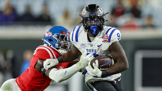 Duke Blue Devils running back Jaquez Moore (9) is chased by Mississippi Rebels linebacker Suntarine Perkins (4).