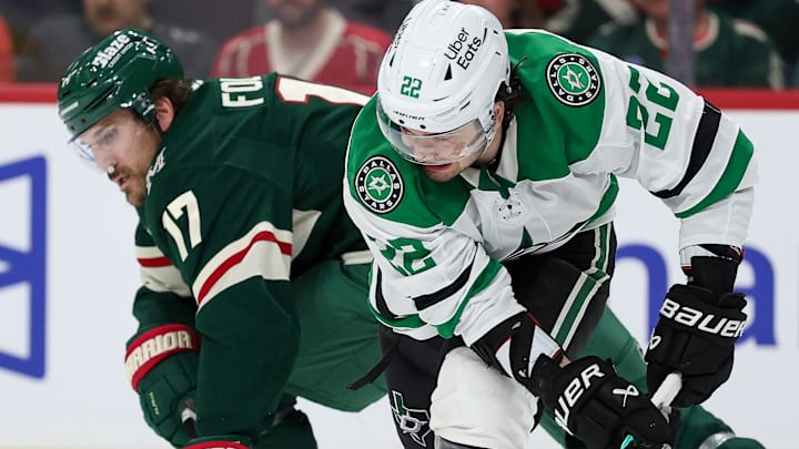 Apr 22, 2026; Saint Paul, Minnesota, USA; Dallas Stars center Mavrik Bourque (22) and Minnesota Wild left wing Marcus Foligno (17) compete for the puck  during the third period in game three of the first round of the 2026 Stanley Cup Playoffs at Grand Casino Arena. Mandatory Credit: Matt Krohn-Imagn Images