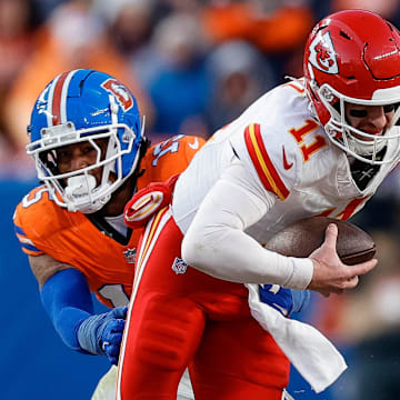 Jan 5, 2025; Denver, Colorado, USA; Kansas City Chiefs quarterback Carson Wentz (11) is sacked by Denver Broncos linebacker Nik Bonitto (15) in the third quarter at Empower Field at Mile High. 