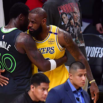 Apr 30, 2025; Los Angeles, California, USA; Minnesota Timberwolves forward Julius Randle (30) meets with Los Angeles Lakers forward LeBron James (23) following game five of first round for the 2025 NBA Playoffs at Crypto.com Arena. Mandatory Credit: Gary A. Vasquez-Imagn Images