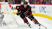 Feb 1, 2025; Raleigh, North Carolina, USA;  Carolina Hurricanes right wing Mikko Rantanen (96) skates with the puck against the Los Angeles Kings during the third period at Lenovo Center. Mandatory Credit: James Guillory-Imagn Images