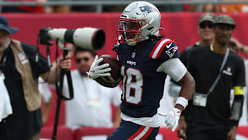 Nov 9, 2025; Tampa, Florida, USA; New England Patriots wide receiver Kyle Williams (18) runs for a touchdown during the second quarter against the Tampa Bay Buccaneers at Raymond James Stadium.