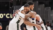  Antetokounmpo and Lillard embrace. 