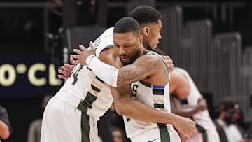  Antetokounmpo and Lillard embrace. 