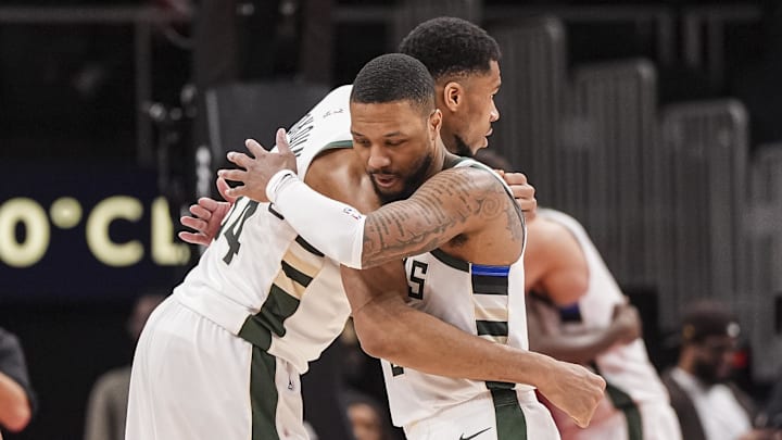  Antetokounmpo and Lillard embrace. 