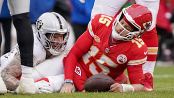 Dec 25, 2023; Kansas City, Missouri, USA; Kansas City Chiefs quarterback Patrick Mahomes (15) reacts after being sacked by Las Vegas Raiders defensive end Maxx Crosby (98) during the game at GEHA Field at Arrowhead Stadium. Mandatory Credit: Denny Medley-Imagn Images