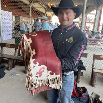 In honor of his mother's two bouts with breast cancer, Shane O'Connell  has a pink ribbon proudly displayed on his chaps. 