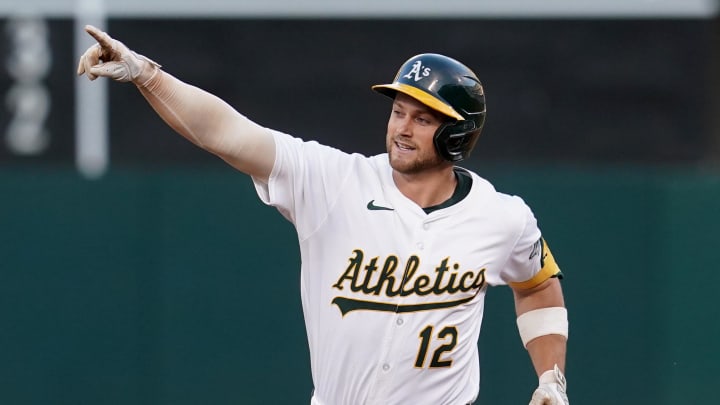 Oakland Athletics shortstop Max Schuemann (12) points towards left field after hitting a three-run home run against the Los Angeles Angels in the fourth inning at Oakland-Alameda County Coliseum on July 19.