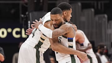 Milwaukee Bucks forward Giannis Antetokounmpo and guard Damian Lillard react after defeating the Atlanta Hawks at State Farm Arena on March 4.