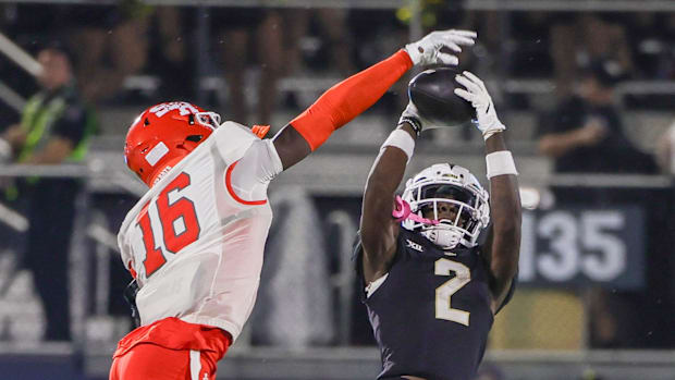 UCF Knights wide receiver Kobe Hudson catches a pass against Sam Houston State Bearkats defensive back Joe Swen. 