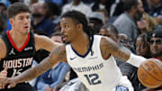 Nov 5, 2025; Memphis, Tennessee, USA; Memphis Grizzlies guard Ja Morant (12) dribbles as Houston Rockets guard Reed Sheppard (15) defends during the fourth quarter at FedExForum. Mandatory Credit: Petre Thomas-Imagn Images