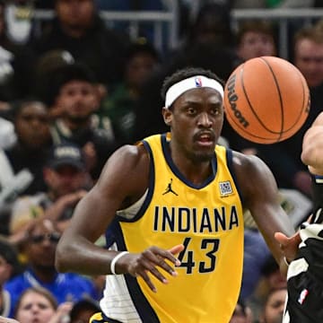 Apr 27, 2025; Milwaukee, Wisconsin, USA; Milwaukee Bucks forward Giannis Antetokounmpo (34) passes the ball away from Indiana Pacers forward Pascal Siakam (43) in the first quarter during game four of first round for the 2024 NBA Playoffs at Fiserv Forum. Mandatory Credit: Benny Sieu-Imagn Images