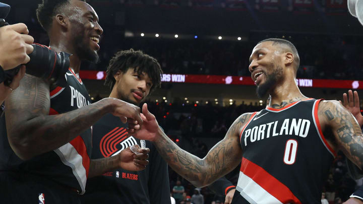 Jan 25, 2023; Portland, Oregon, USA;  Portland Trail Blazers guard Damian Lillard (0) is congratulated by teammate forward Nassir Little (10) after scoring 60 points at Moda Center. Mandatory Credit: Jaime Valdez-USA TODAY Sports