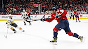 Oct 15, 2024; Washington, District of Columbia, USA; Washington Capitals left wing Alex Ovechkin (8) shoots the puck as Vegas Golden Knights center Brett Howden (21) defends in the first period at Capital One Arena. Mandatory Credit: Geoff Burke-Imagn Images