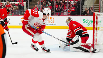 Mar 14, 2025; Raleigh, North Carolina, USA;  Detroit Red Wings center Dylan Larkin (71) scoring attempt is stopped by Carolina Hurricanes goaltender Frederik Andersen (31) during the second period at Lenovo Center. Mandatory Credit: James Guillory-Imagn Images