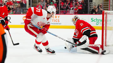 Mar 14, 2025; Raleigh, North Carolina, USA;  Detroit Red Wings center Dylan Larkin (71) scoring attempt is stopped by Carolina Hurricanes goaltender Frederik Andersen (31) during the second period at Lenovo Center. Mandatory Credit: James Guillory-Imagn Images