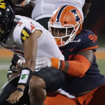 Sep 17, 2021; Champaign, Illinois, USA; Illinois Fighting Illini defensive lineman Jer'Zhan Newton (94) sacks Maryland Terrapins quarterback Taulia Tagovailoa (3) in the first half at Memorial Stadium. Mandatory Credit: Ron Johnson-Imagn Images