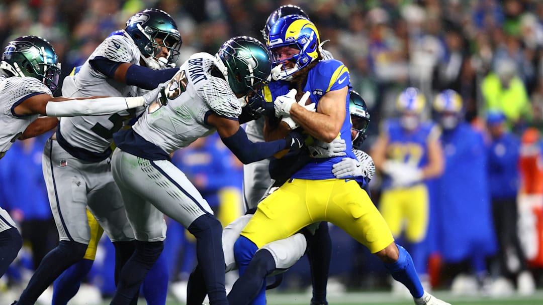 Dec 18, 2025; Seattle, Washington, USA; Seattle Seahawks safety Coby Bryant (8) tackles Los Angeles Rams wide receiver Jordan Whittington (88) in the first half at Lumen Field.