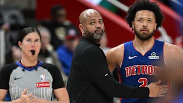 Detroit Pistons head coach J.B. Bickerstaff talks with guard Cade Cunningham (2) during a Charlotte Hornets foul shot in the third quarter at Little Caesars Arena.