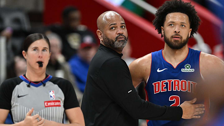 Detroit Pistons head coach J.B. Bickerstaff talks with guard Cade Cunningham (2) during a Charlotte Hornets foul shot in the third quarter at Little Caesars Arena.