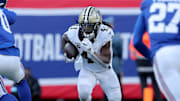 Dec 8, 2024; East Rutherford, New Jersey, USA; New Orleans Saints running back Alvin Kamara (41) runs with the ball against the New York Giants during the second quarter at MetLife Stadium. Mandatory Credit: Brad Penner-Imagn Images