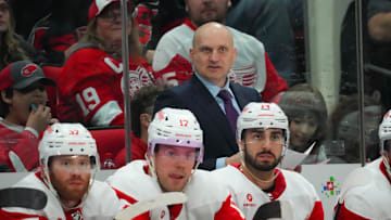Mar 28, 2024; Raleigh, North Carolina, USA;  Detroit Red Wings head coach Derek Lalonde looks on from behind the bench against the Carolina Hurricanes during the second period at PNC Arena. 