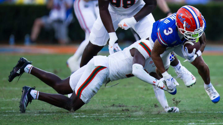 Florida Gators wide receiver Eugene Wilson III (3) is upended during the season opener at Ben Hill Griffin Stadium in Gainesville, FL on Saturday, August 31, 2024 against the University of Miami Hurricanes in the second half. Miami defeated the Gators 41-17. [Doug Engle/Gainesville Sun]