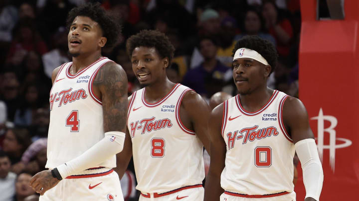 Nov 8, 2023; Houston, Texas, USA; Houston Rockets guard Jalen Green (4) reacts to his basket while forward Jae'Sean Tate (8) and guard Aaron Holiday (0) look on against the Los Angeles Lakers in the second half at Toyota Center. Mandatory Credit: Thomas Shea-USA TODAY Sports