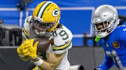 Green Bay Packers wide receiver Christian Watson (9) catches a pass against Detroit Lions cornerback Amik Robertson (21).