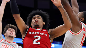 Dec 7, 2024; Columbus, Ohio, USA;  Rutgers Scarlet Knights guard Dylan Harper (2) drives to the basket as Ohio State Buckeyes center Austin Parks (25) and guard Evan Mahaffey (12) defend during the first half at Value City Arena. Mandatory Credit: Joseph Maiorana-Imagn Images