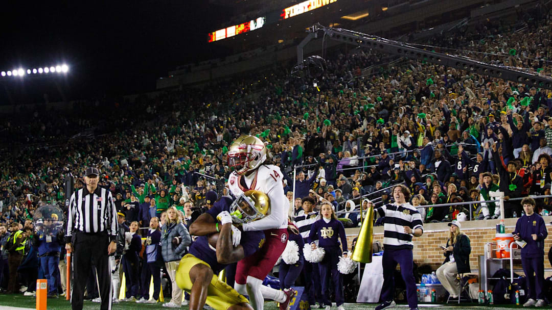 Notre Dame wide receiver Deion Colzie (0) catches a pass in the end zone for a touchdown with Florida State defensive back Cai Bates (14) defending during a NCAA college football game at Notre Dame Stadium on Saturday, Nov. 9, 2024, in South Bend.